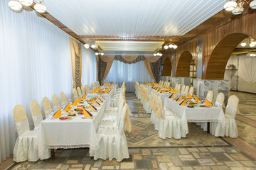 banquet hall of the restaurant, beautifully decorated tables with food	