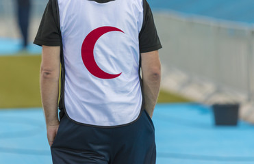 Man wearing Red Crescent shirt. Red Crescent is the part of the International Red Cross Movement