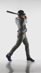 Caucasian professional baseball player batter wearing generic uniform posing as if he was hitting a ball isolated on white background © supamotion