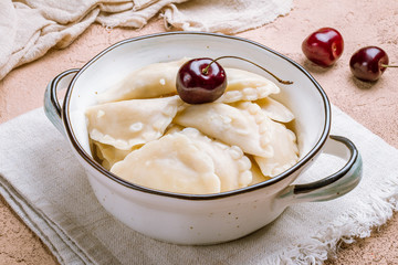 dumplings with cherries on a plate