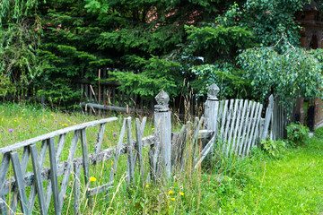 Old, abandoned wooden fence in front of old summer house on popular location in Transylvania.