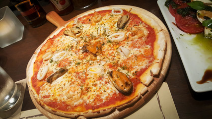 seafood pizza on table wood backgrounds