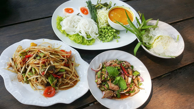 thai food and vegetables on table wood backgrounds