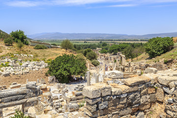 Ephesus, Izmir, Turkey - July 8, 2018 : People are walking through ancient streets of Ephesus from domitian temple to library of Celsus