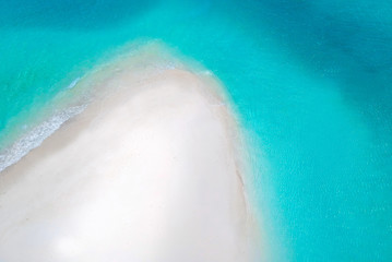 White sand bank and turquoise ocean from above