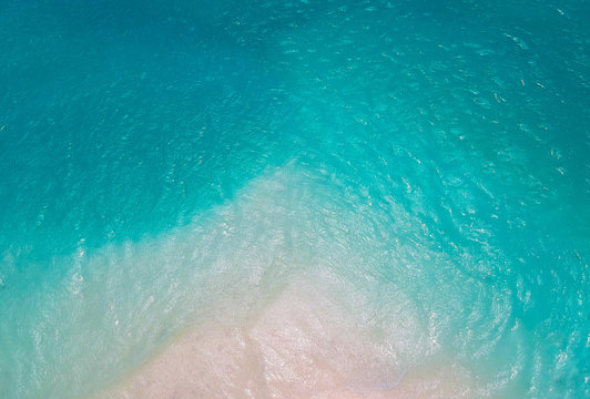 White sand bank and turquoise ocean from above
