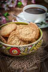 Stack of freshly baked oat biscuits in a bowl.