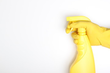 hand yellow glove and yellow bottle sprayer