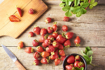 Fresh Healthy strawberry on cutting board over wooden background.