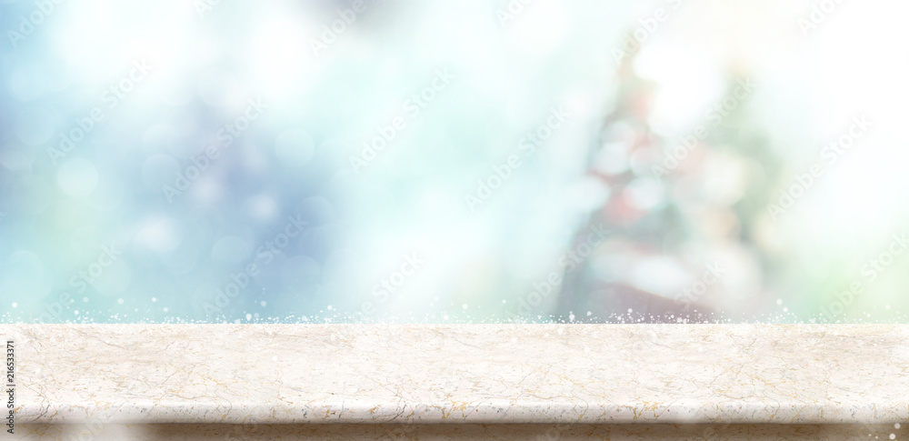 Leinwandbilder empty marble stone table top with abstract bokeh blur christmas tree and snow fall background with b