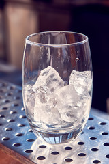 Glass for water with ice is on the bar