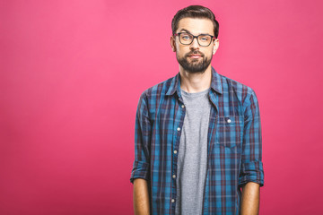 Fototapeta premium Portrait of a young man thoughtful face. Isolated on a pink background.