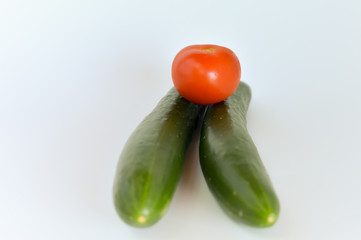 Tomatoes and cucumbers isolated on white background. selective focus.