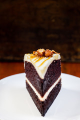 Dark Almond Chocolate cake with caramel sauce on top close up