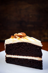 Dark Almond Chocolate cake with caramel sauce on top close up