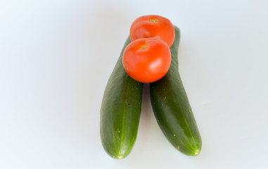 Tomatoes and cucumbers isolated on white background. selective focus.