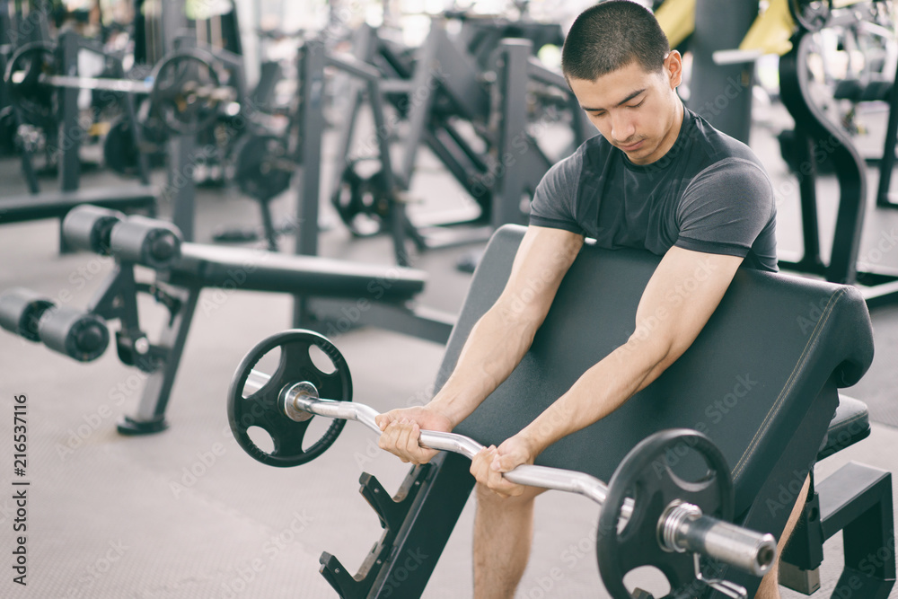 Wall mural asian man exercising in the gym, fitness, health, body good.