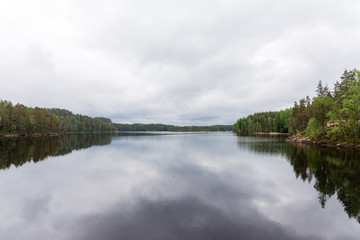 Fototapeta na wymiar Peaceful lake in finnish lapland with some dark clouds