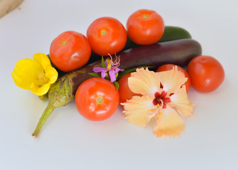 Egg plant, tomatoes, and cucumber isolated on bright background. Selective focus.