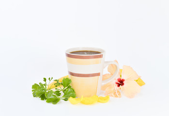 a cup of coffee with tropical flowers isolated on white background. selective focus.