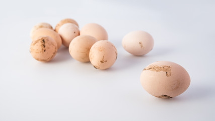 Group of dirty chicken eggs on gray background, banner 16x9