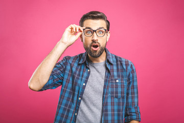 OMG! It's incredible! Portrait of handsome young man in glasses looking at camera while standing...