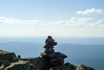 stone pyramid - a road sign on the mountain pass, reminiscent of a primitive sculpture