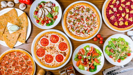 Italian pizzas and salads top view
