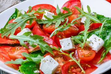 Salad with tomato arugula and feta cheese