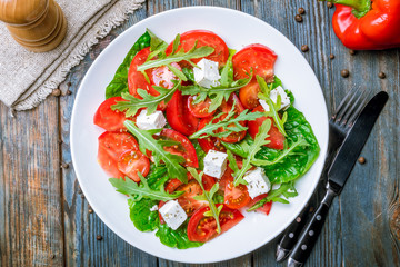 Salad with tomato arugula and feta cheese