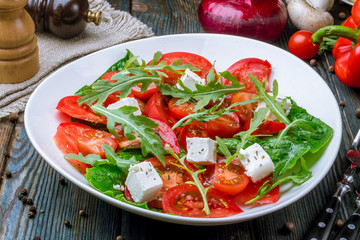 Salad with tomato arugula and feta cheese
