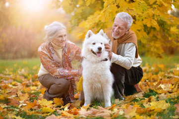 portrait of beautiful caucasian senior couple with dog