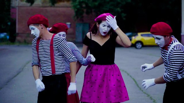 Four mimes imitate car accident at the city