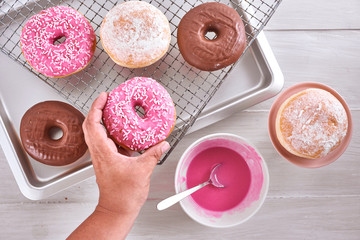 Donuts over rack and table glazing. Motion. Top view.