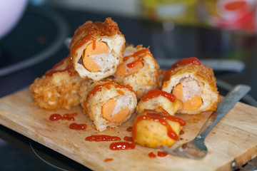 Tasty corn dogs with ketchup on plate