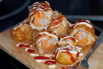 Tasty corn dogs with ketchup on plate
