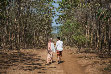 muslim couple enjoy their time walking in the wild