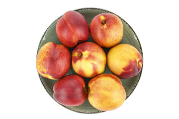 a lot of nectarines in a round plate