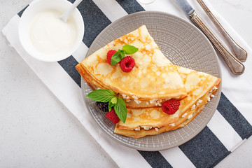 Crepes, thin pancakes with fresh raspberry,blackberry and cottage cheese. top view