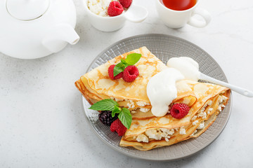 Crepes, thin pancakes with fresh raspberry,blackberry and cottage cheese.