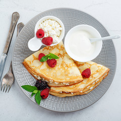Crepes, thin pancakes with fresh raspberry,blackberry and cottage cheese. top view