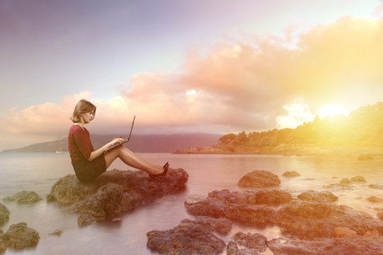 Concept of workoholic business woman working at the beach