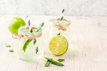 Healthy exotic detox drink, aloe vera or cactus juice with lime, on light concrete background copy...