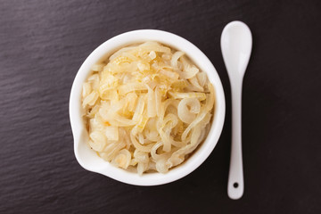 Homemade caramelized onions in frying pan. Vegetarian food..