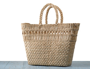 Straw bag on the table with isolated background