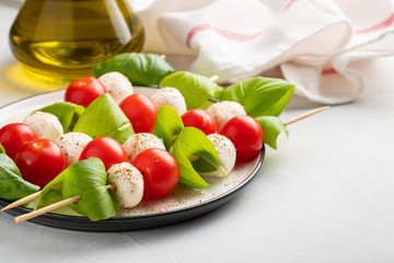 Caprese salad - skewer with tomato, mozzarella and basil, italian food and healthy vegetarian diet...