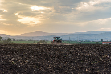 Tractor plowing fields.