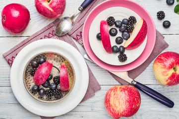 Red apples, blackberries and blueberries in plates