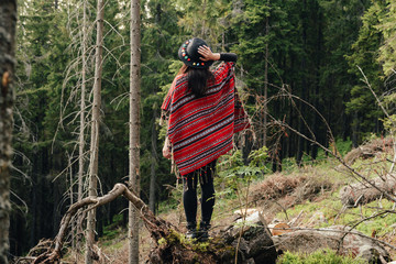 woman traveler  and looking at amazing mountains and forest, wanderlust travel concept, space for...