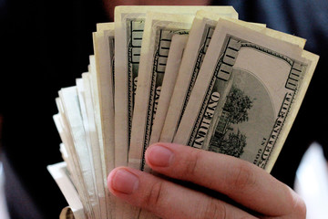 Cash of hundred dollar bills. A pile of one hundred US banknotes .100 Dollar.